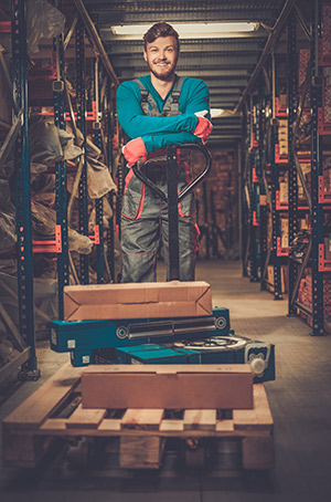 loader using hand pallet truck in a warehouse PMBZKEH
